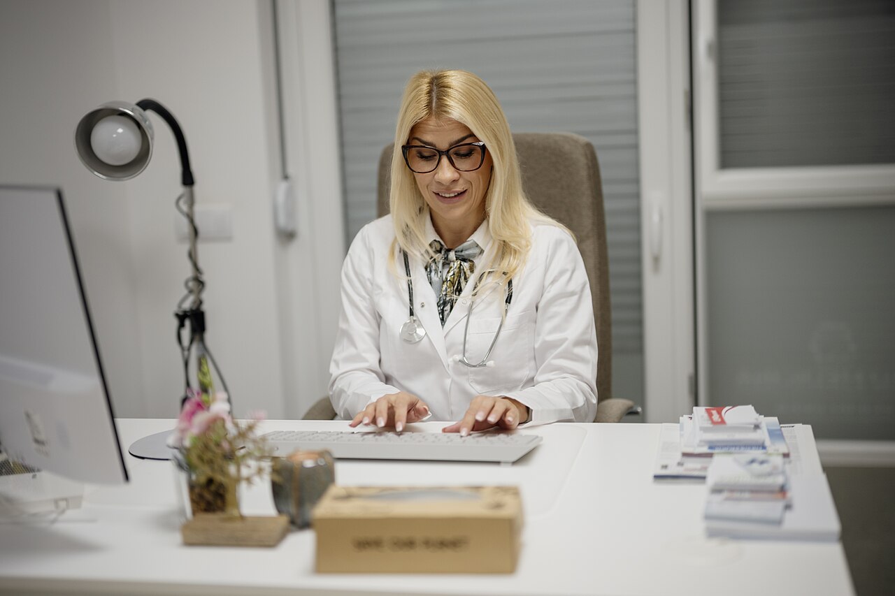 Medical billing specialist reviewing accounts receivable and claims on a computer